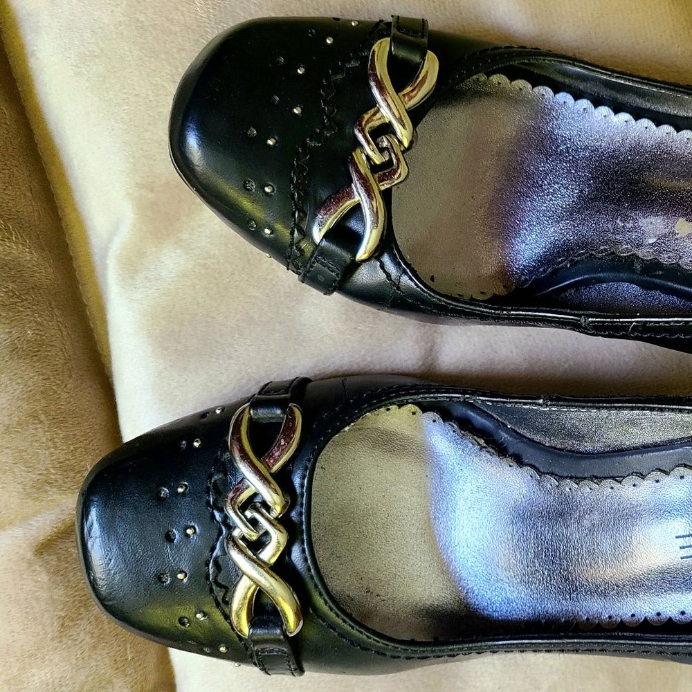 Black shoes with buckle detail.